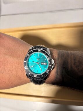 Refurbished vintage teal Seiko 5 automatic watch w/ black and silver bezel